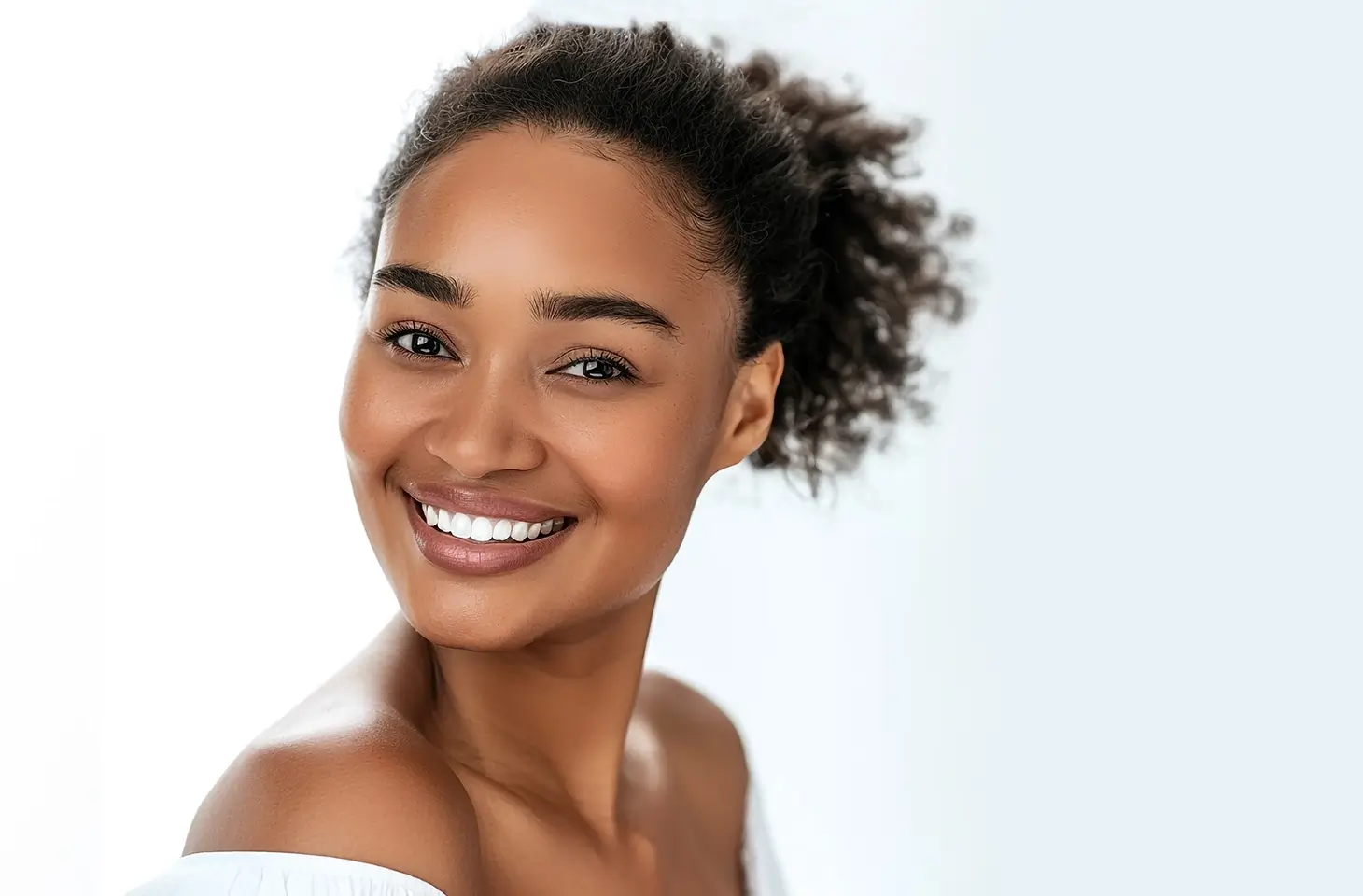 Beautiful young woman with great white teeth smiling happily
